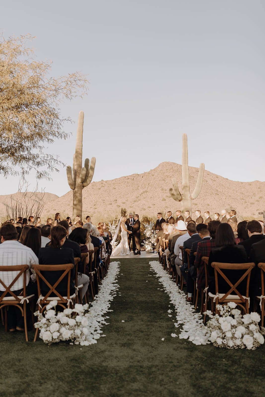 Wedding ceremony at Arizona destination wedding with cactus and mountains in the background