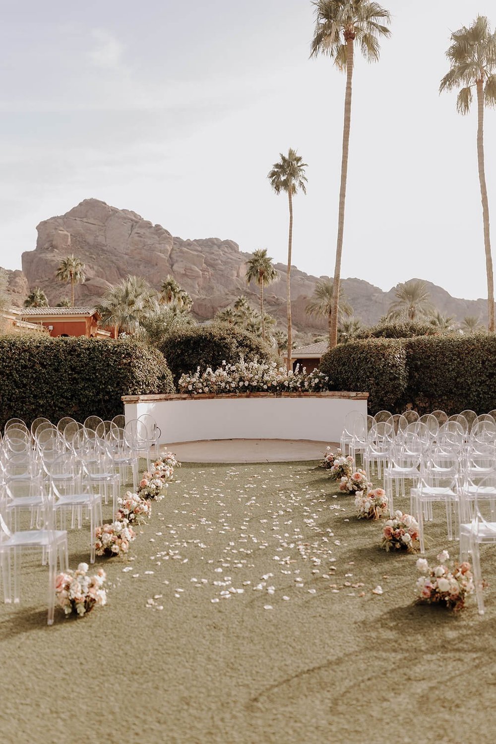 Ceremony lawn with mountains and palm trees in background at luxury Scottsdale wedding