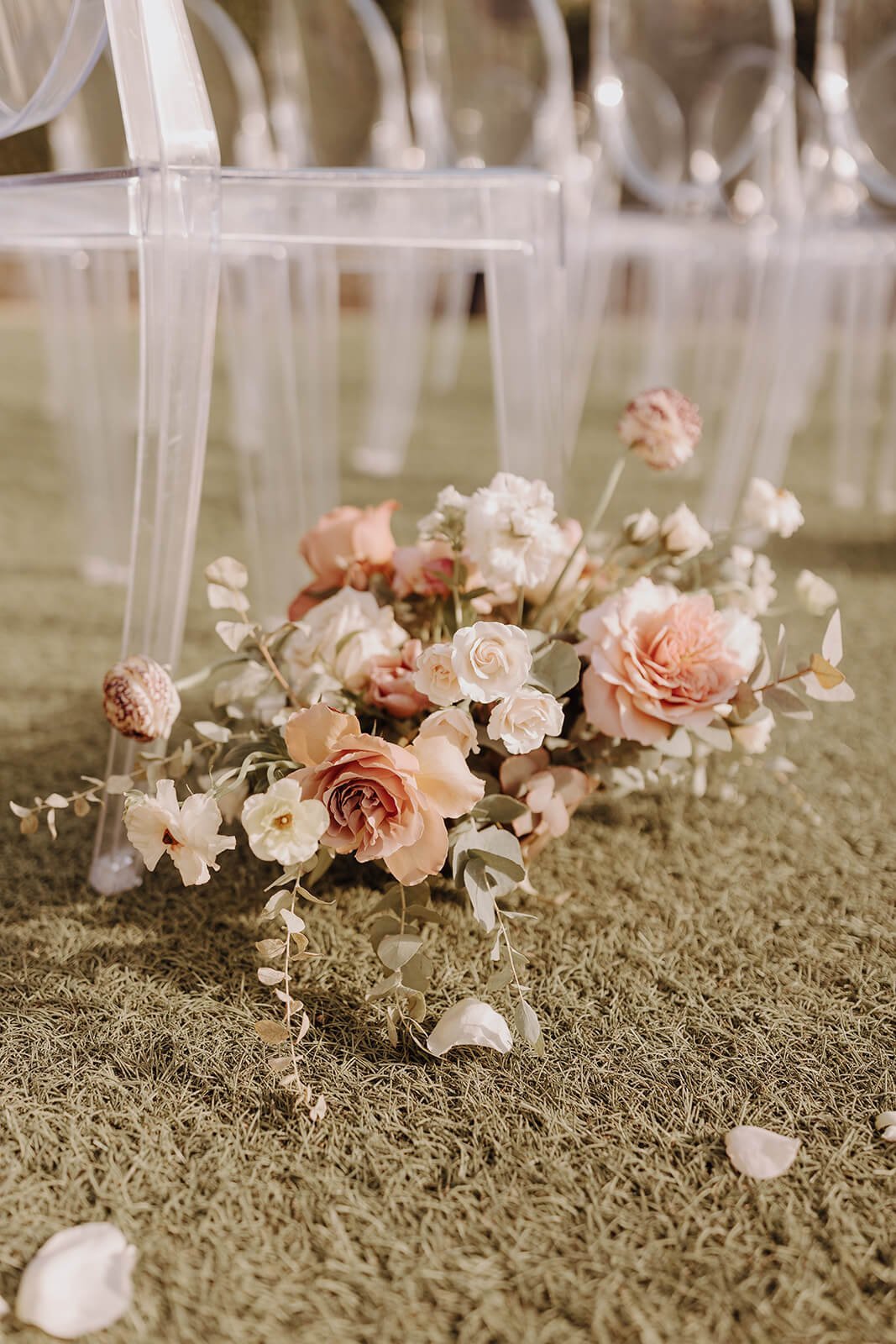 Floral arrangement lining ceremony aisle outdoors at luxury Scottsdale wedding