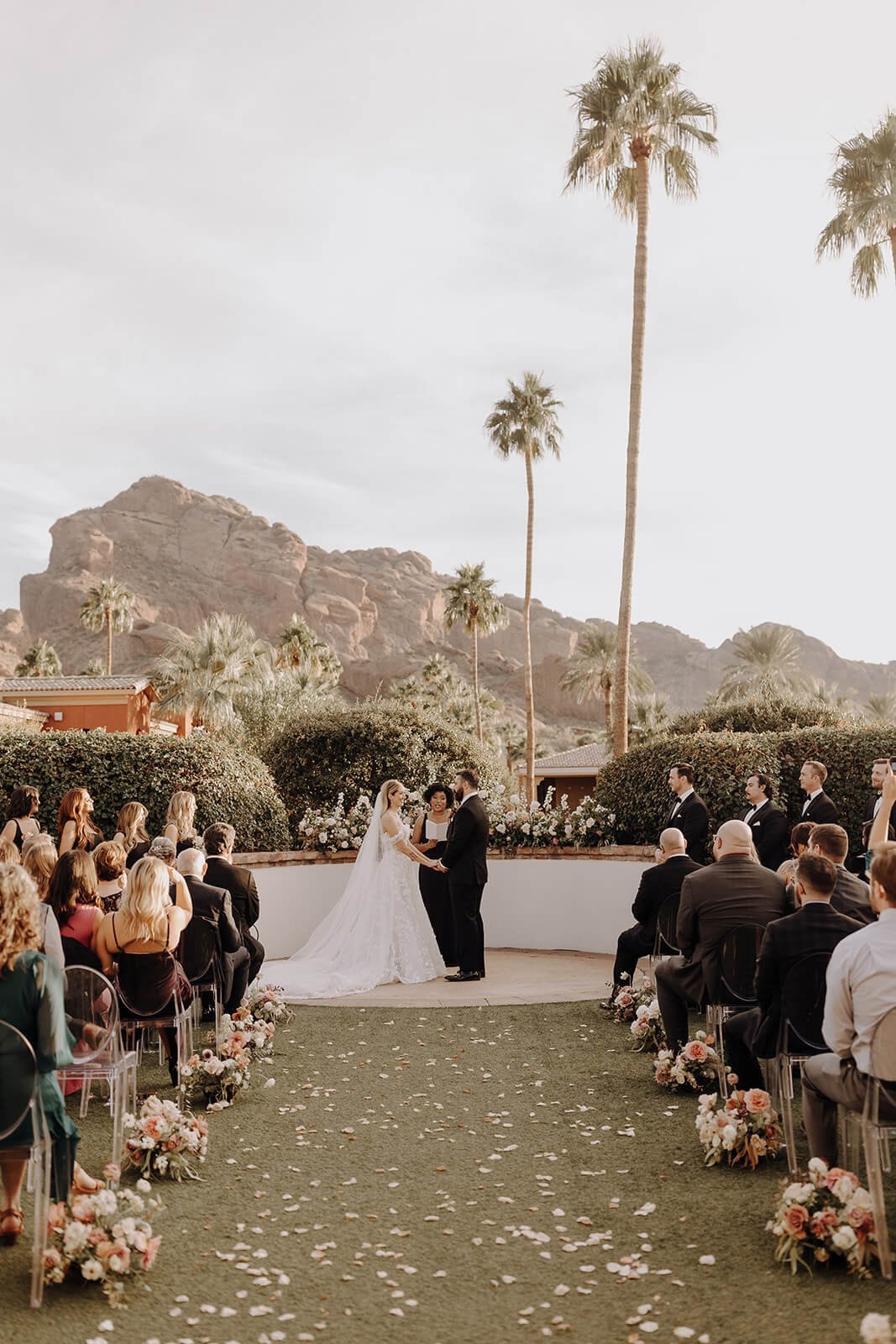 Bride and groom at outdoor ceremony with mountains in the background
