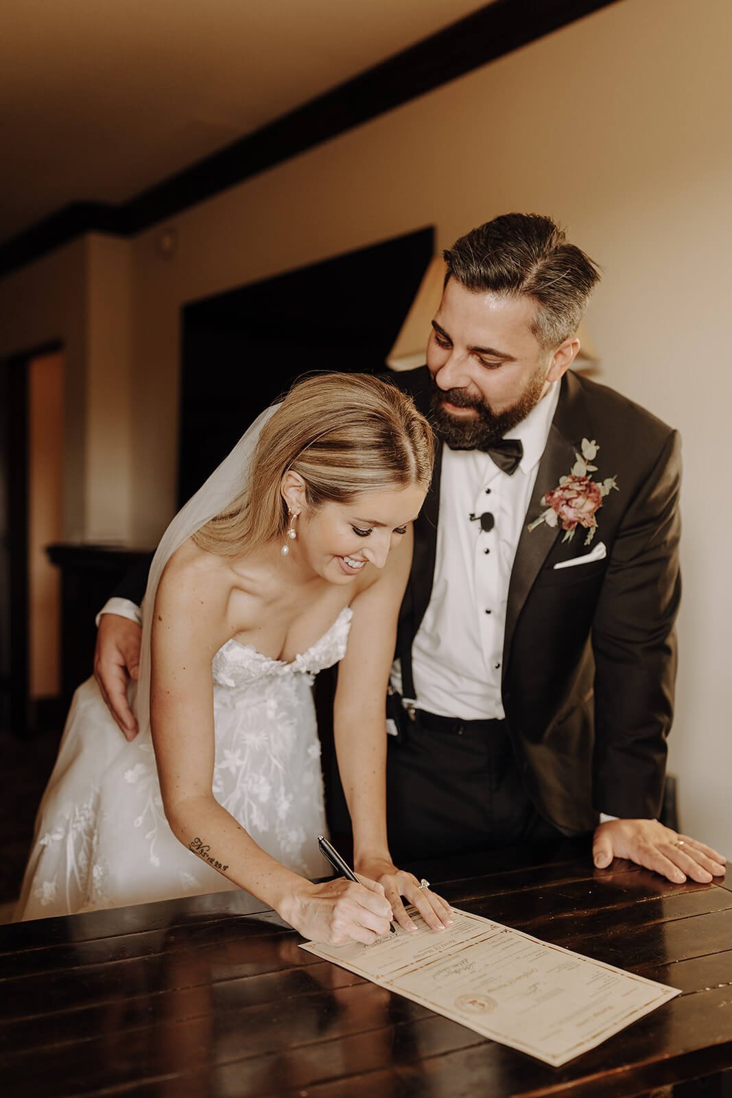 Bride and groom signing marriage license at Scottsdale wedding