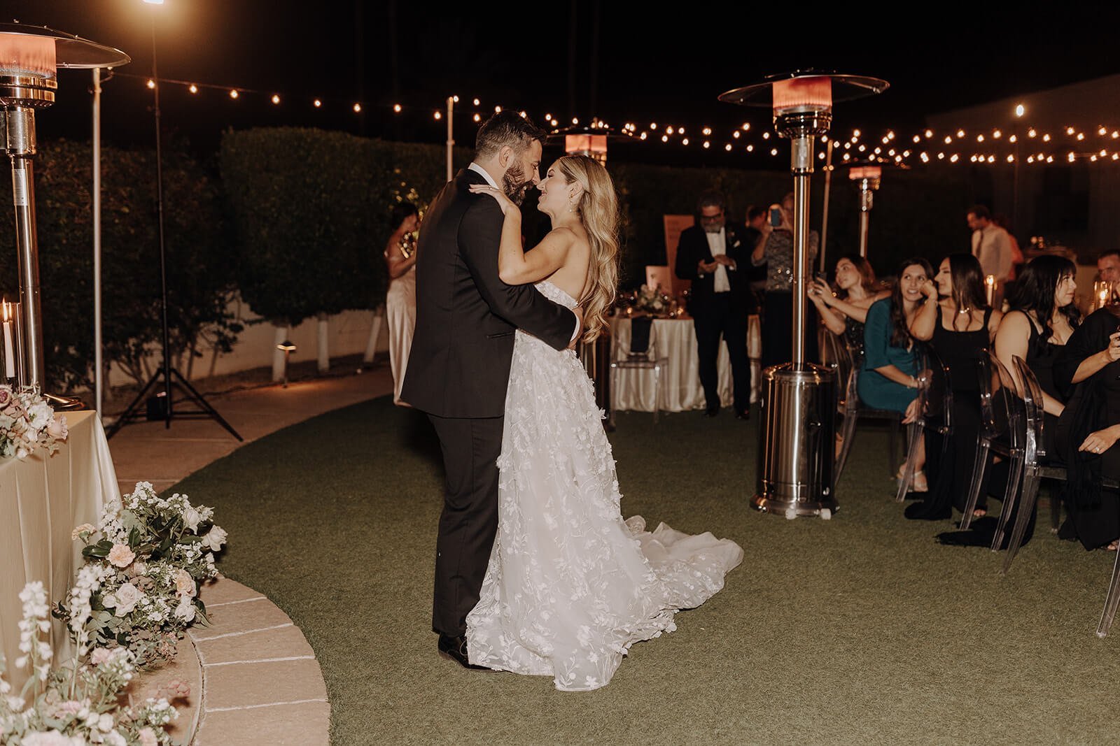 Bride and groom first dance outdoors under lights at luxury Scottsdale wedding