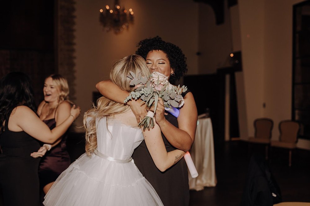 Bride hugs wedding guest at luxury Scottsdale wedding reception