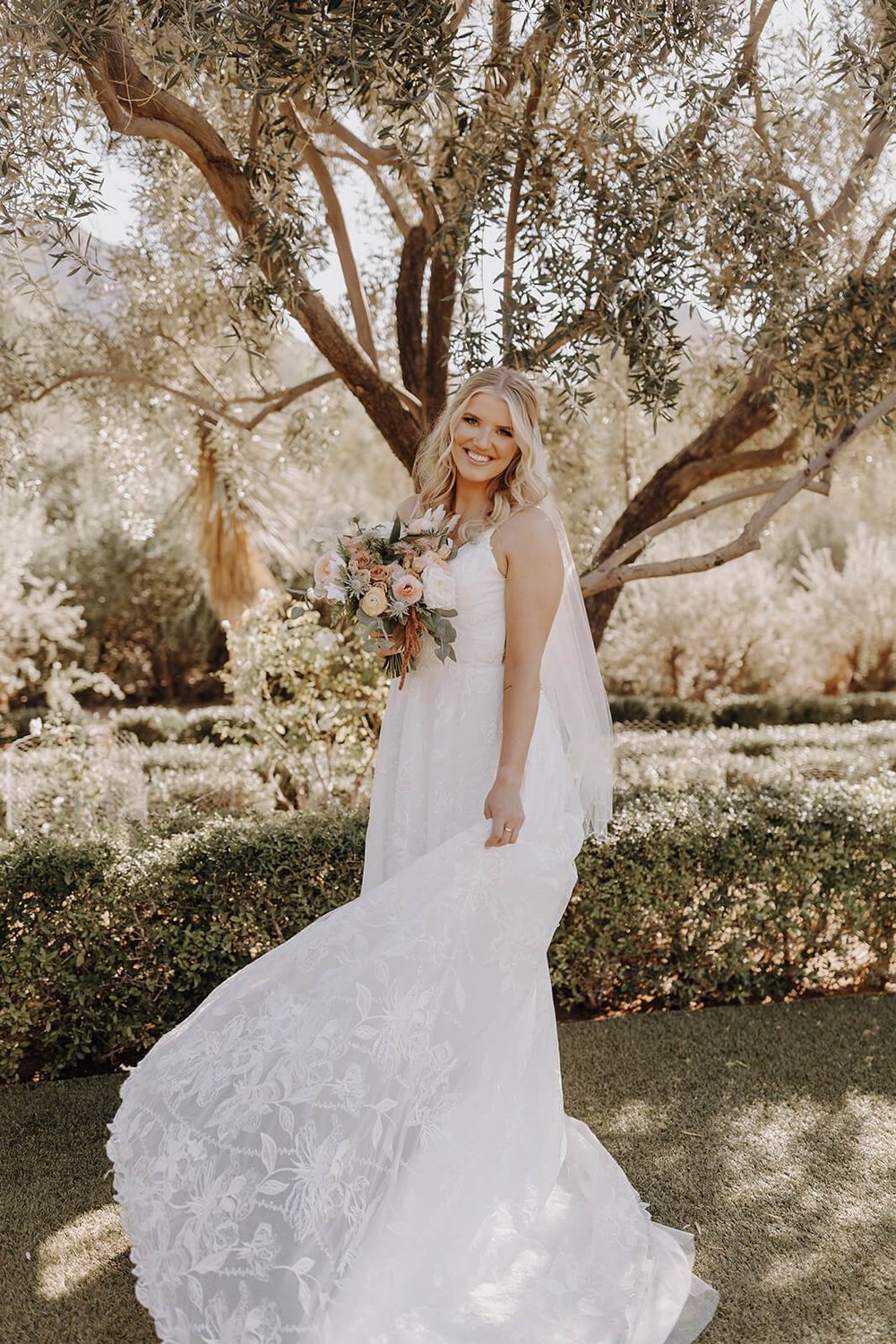 Bride in nature with floral bouquet 