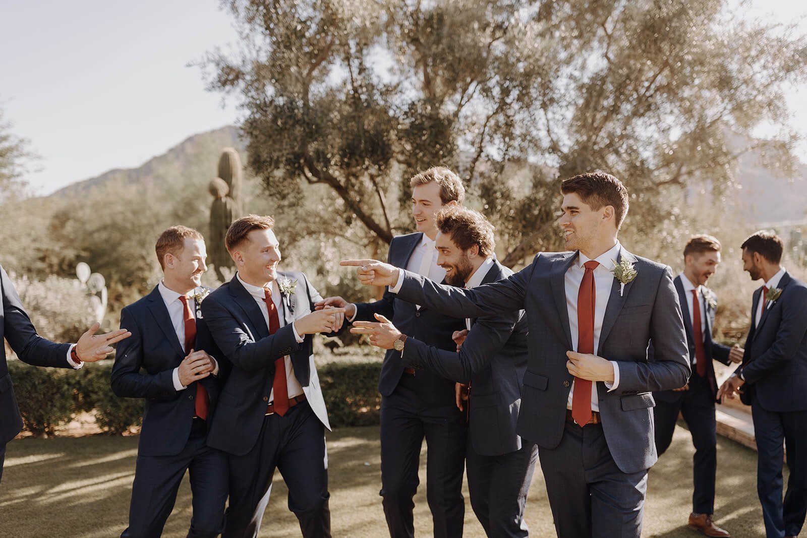 Desert wedding groom with groomsmen having fun