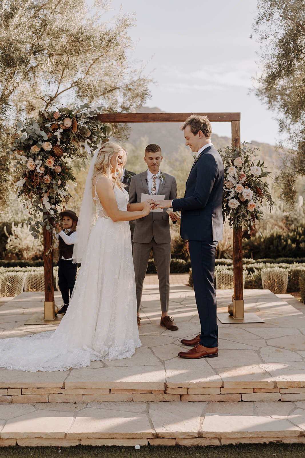 Bride and groom saying vows in Arizona desert with mountains in the background 