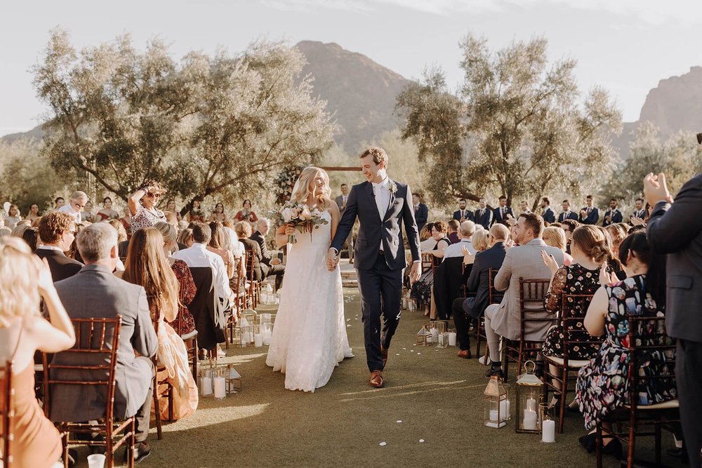 Bride and groom just married recessional in outdoor desert wedding