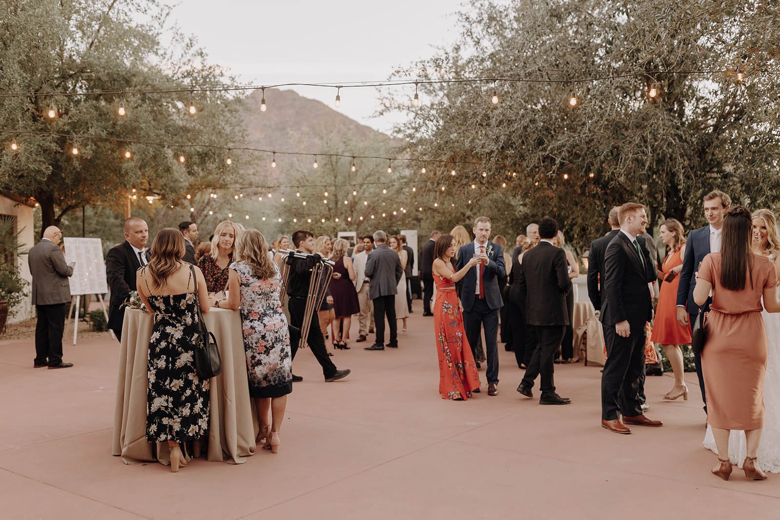 Outdoor desert wedding happy hour with mountains in the background