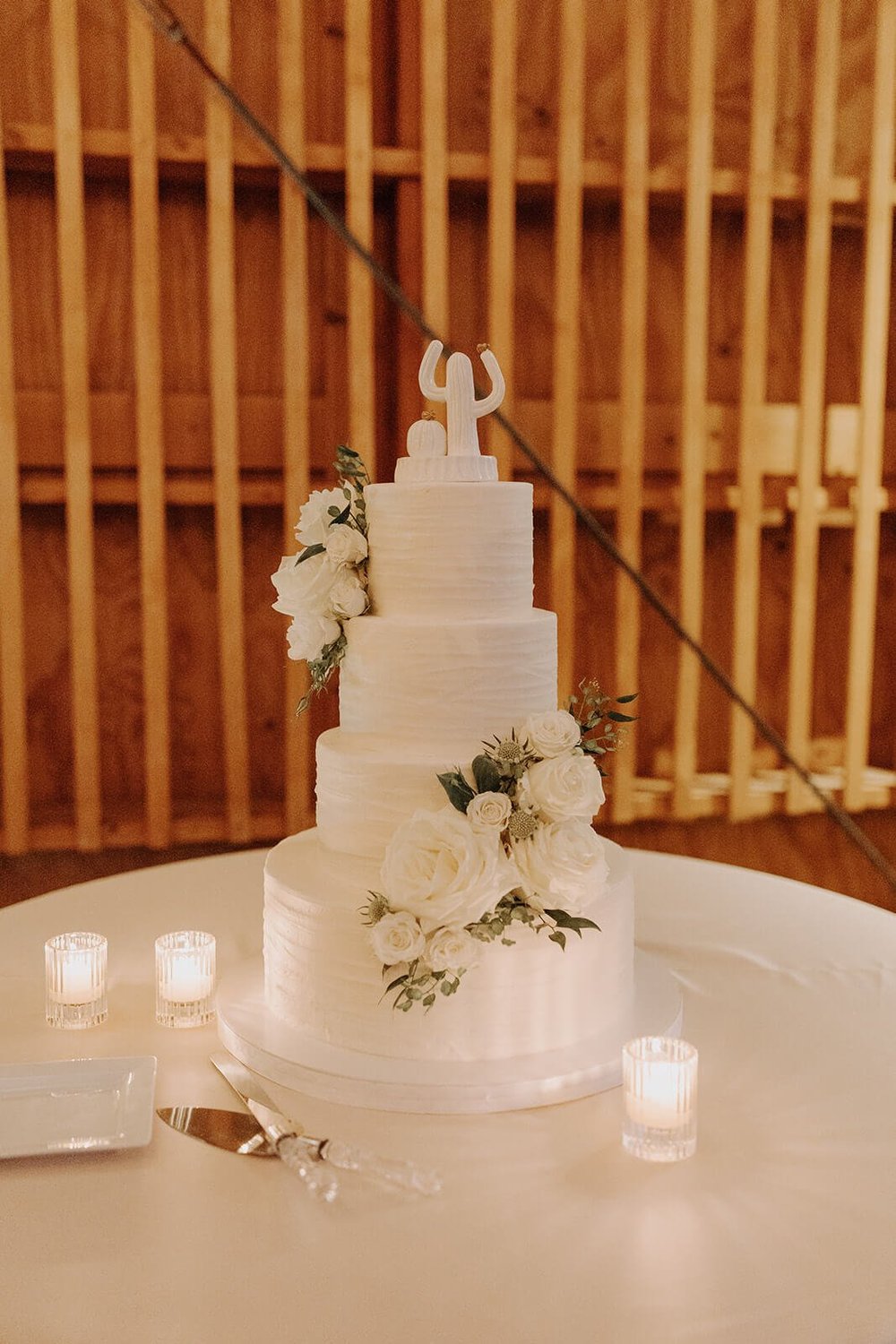 White three tier wedding cake with white florals