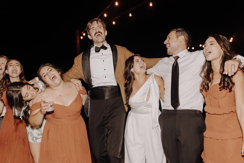 Bride and groom dance with guests at The Paseo wedding venue