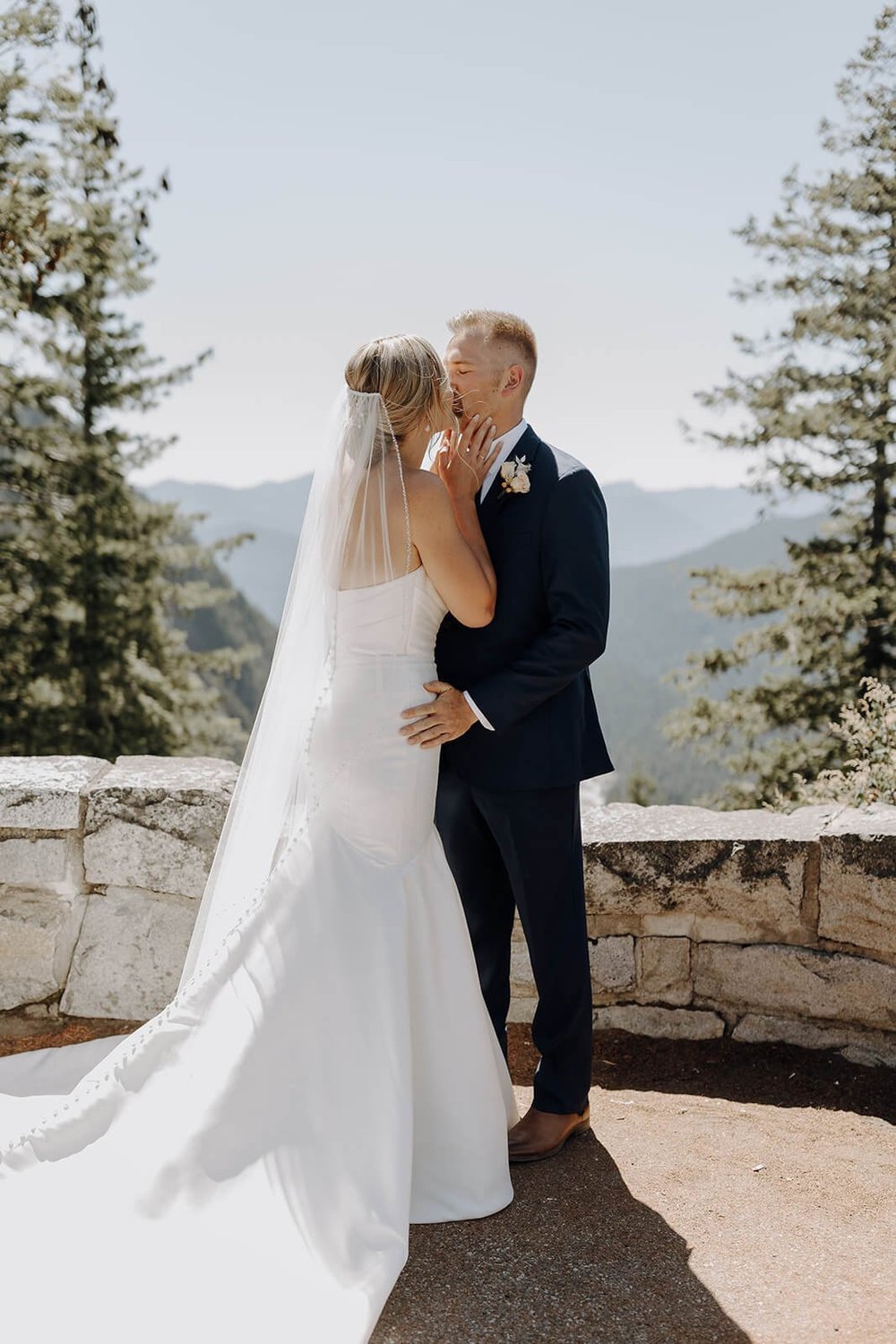 Bride and groom kiss after first look at Mount Rainier