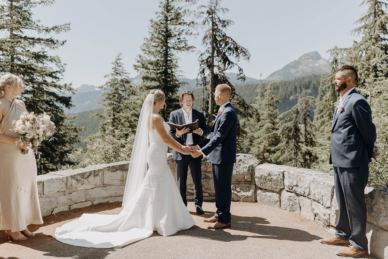Bride and groom holding hands during Mount Rainier wedding ceremony