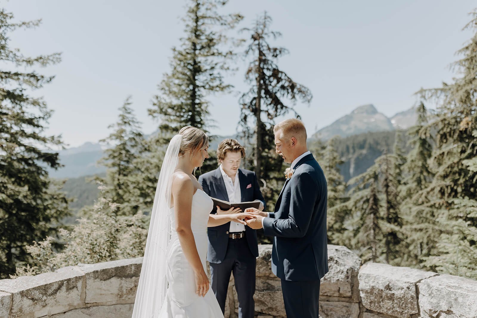 Bride and groom exchange rings during Mount Rainier elopement ceremony