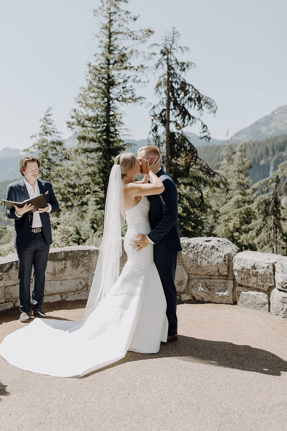 Bride and groom kiss during Mount Rainier wedding ceremony