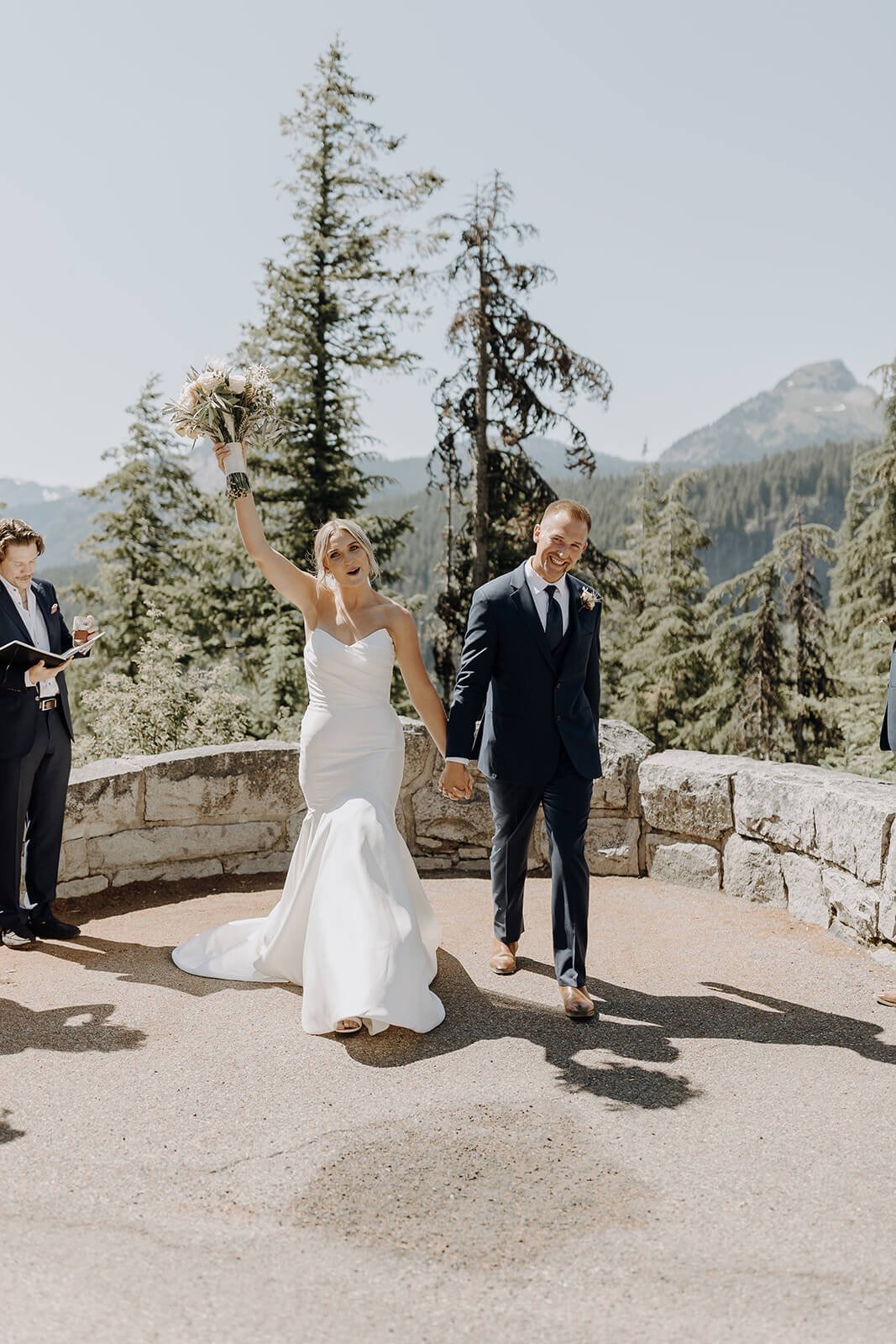 Bride and groom cheer as they exit the Mount Rainier wedding ceremony