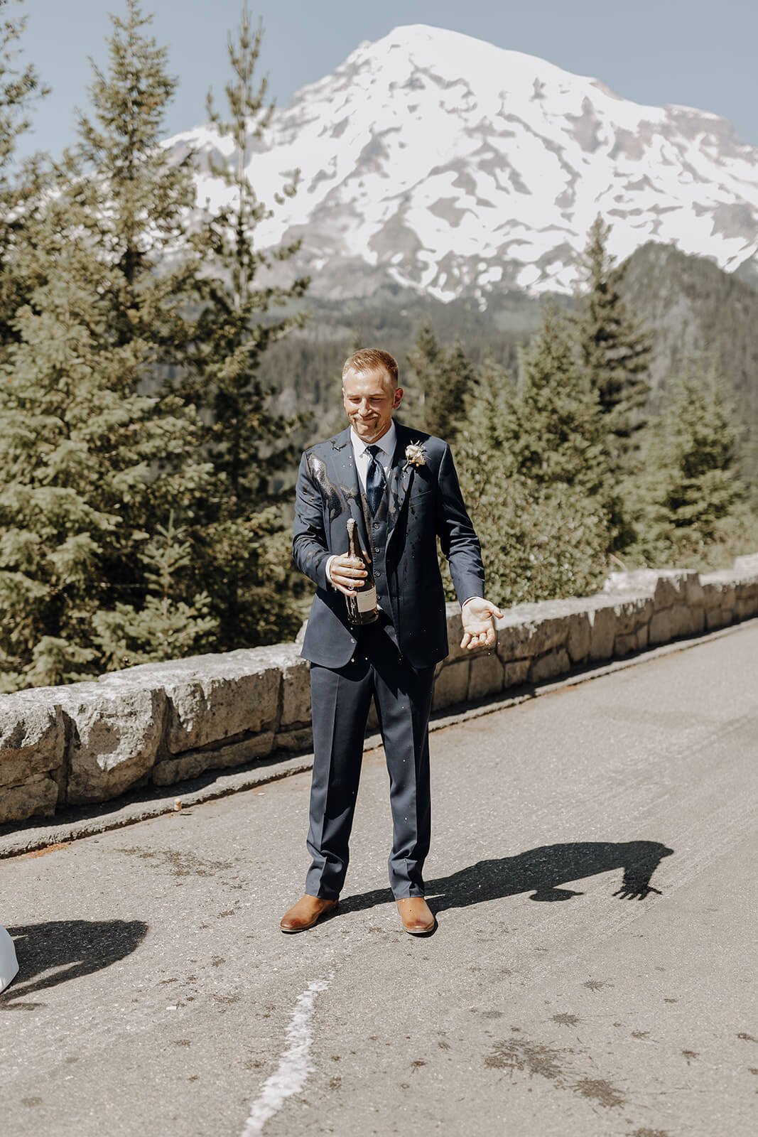 Groom pops bottle of champagne