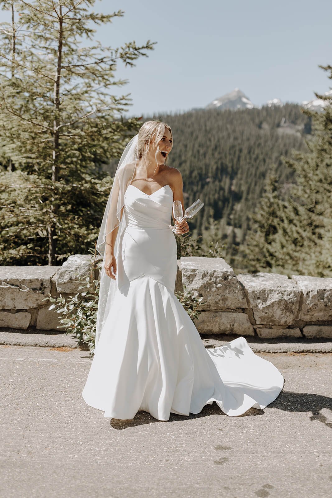 Bride holding champagne glasses