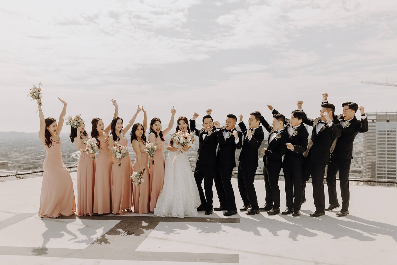 Wedding party cheering during city wedding in California