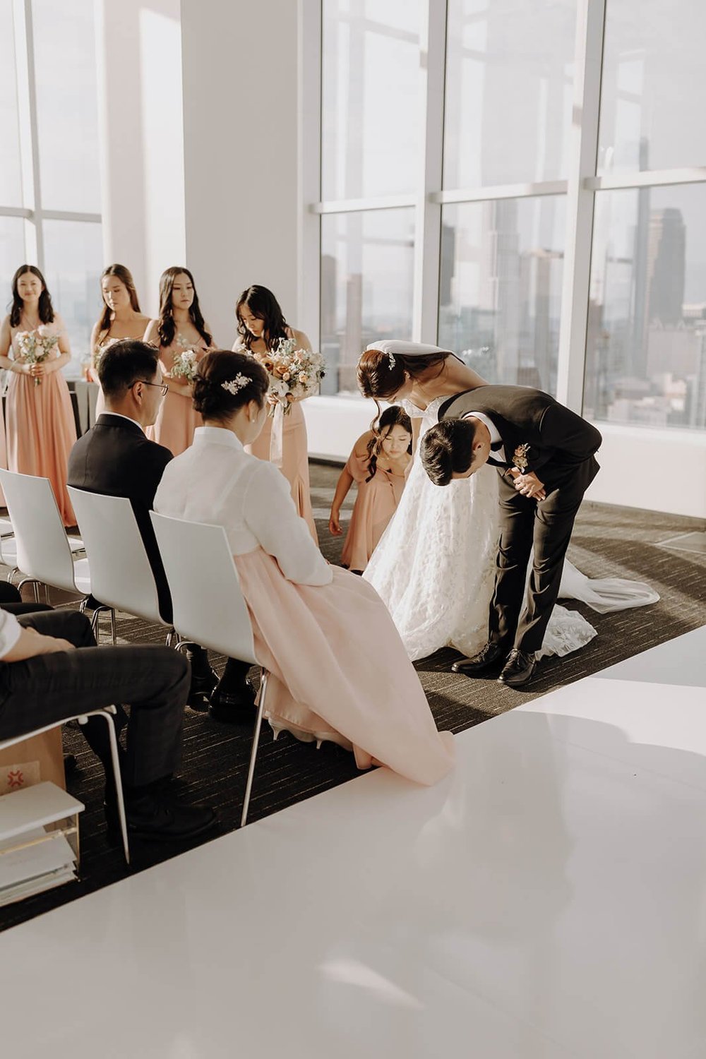 Bride and groom bow to parents at cultural wedding in Los Angeles