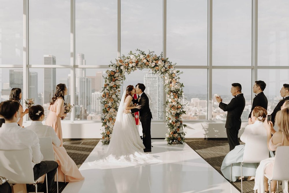 Bride and groom kiss at the altar during Los Angeles wedding