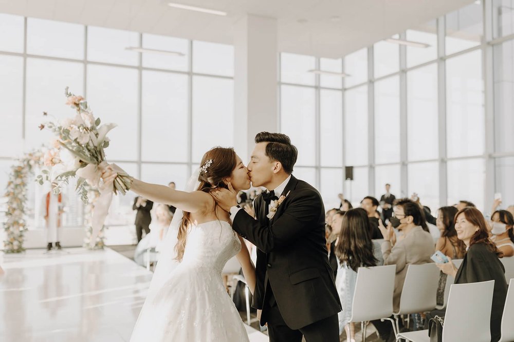 Bride and groom kiss during wedding exit