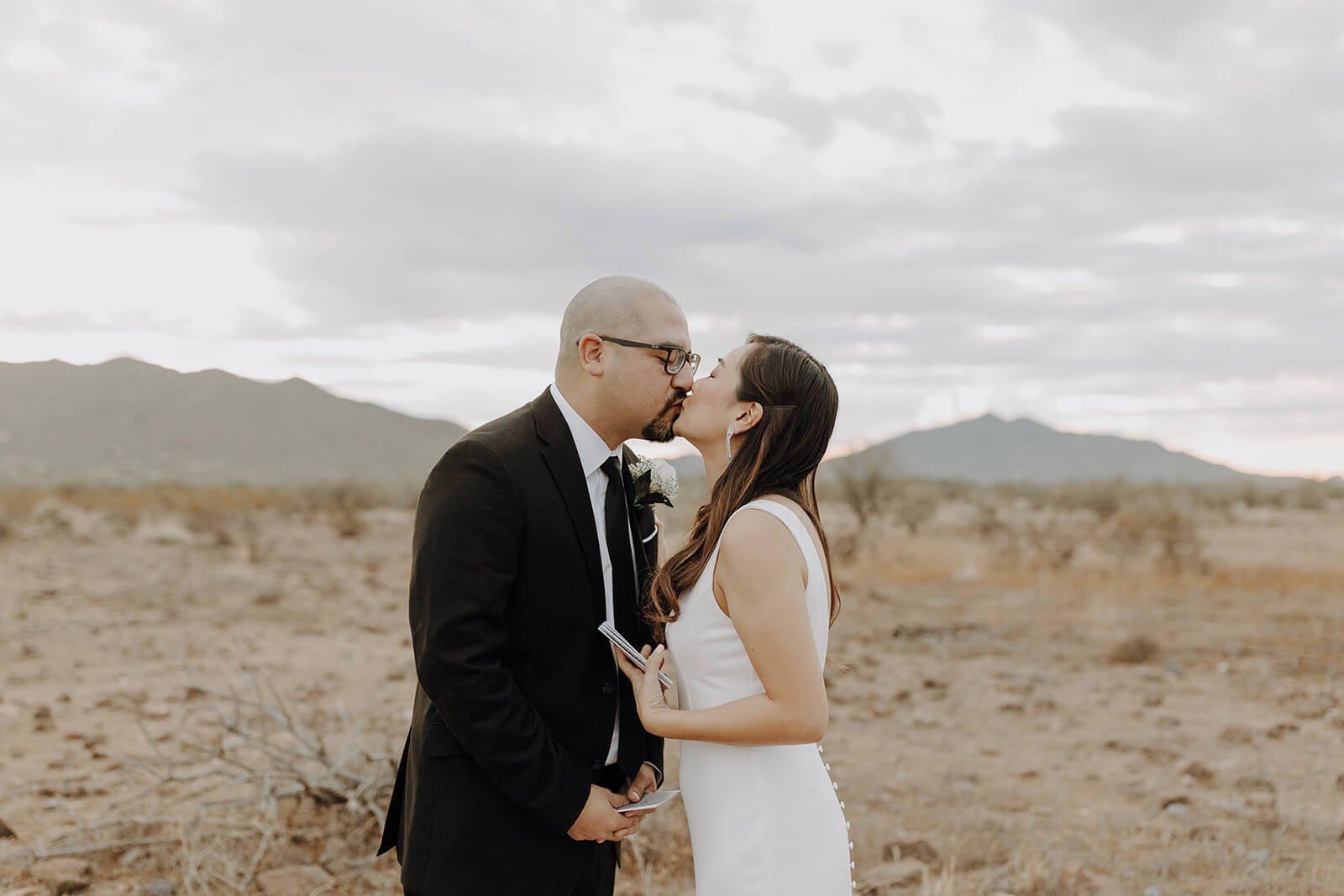 Bride and groom kiss in the Arizona desert