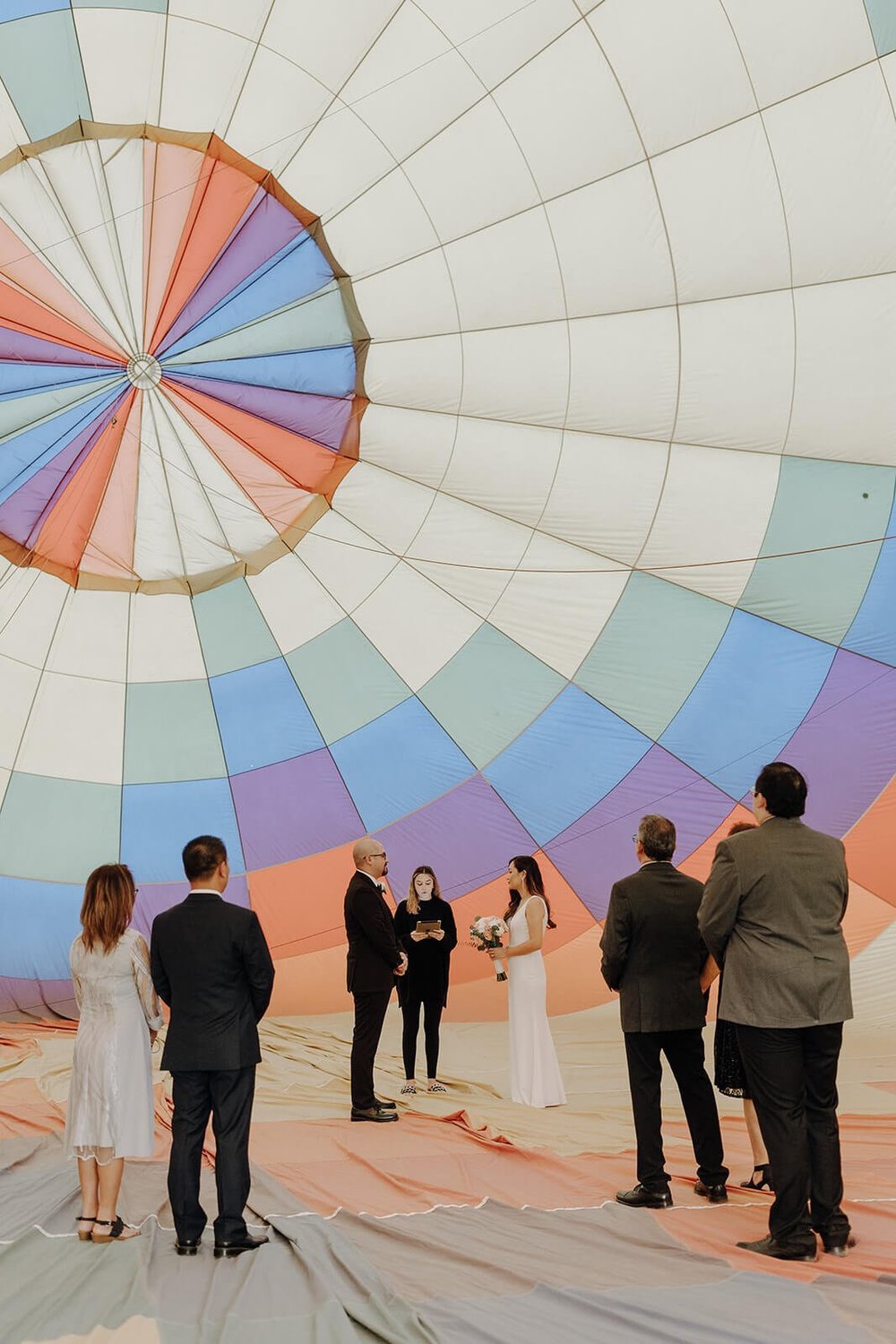 Bride and groom exchange vows during hot air balloon elopement