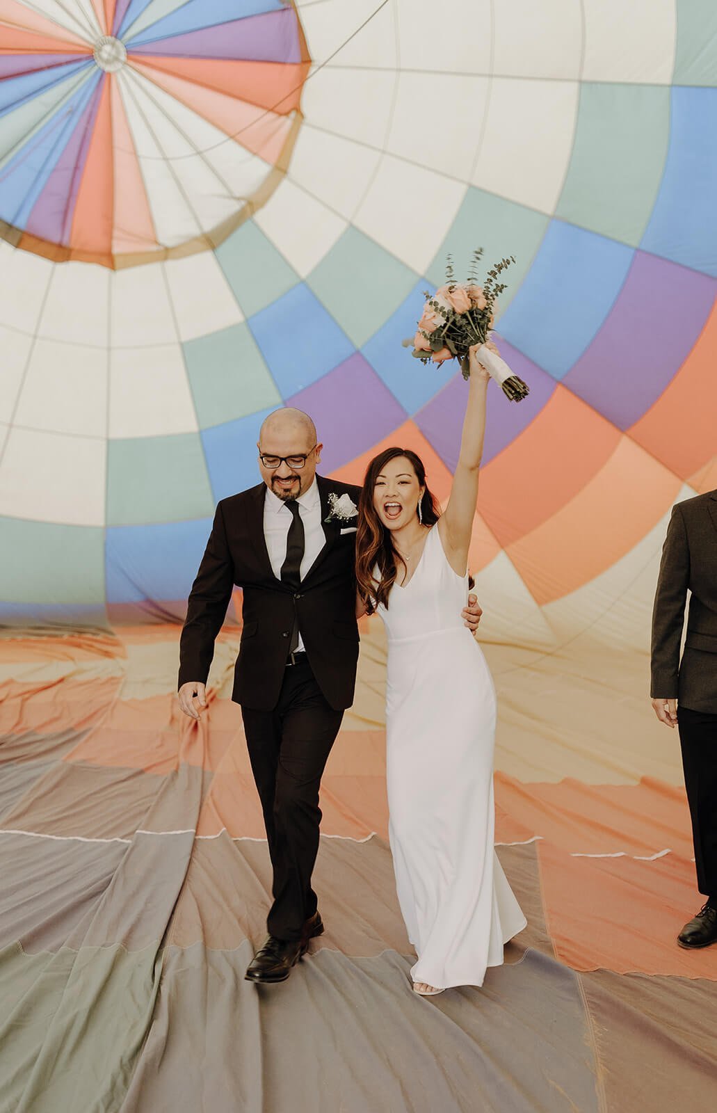 Bride and groom celebrate after hot air balloon elopement ceremony