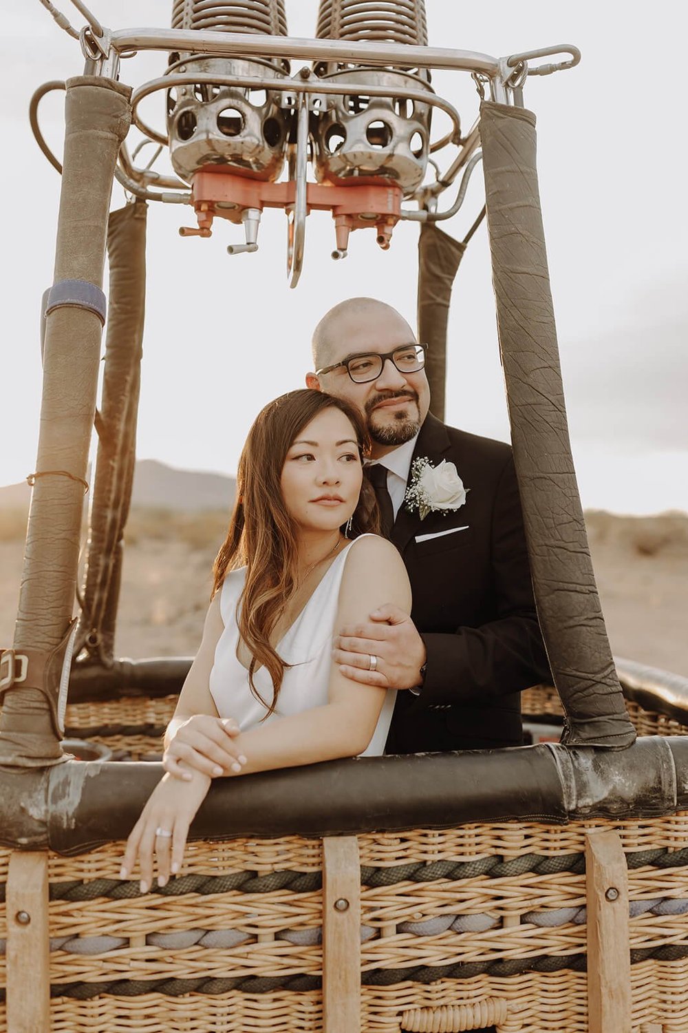Bride and groom couple portraits inside a hot air balloon basket
