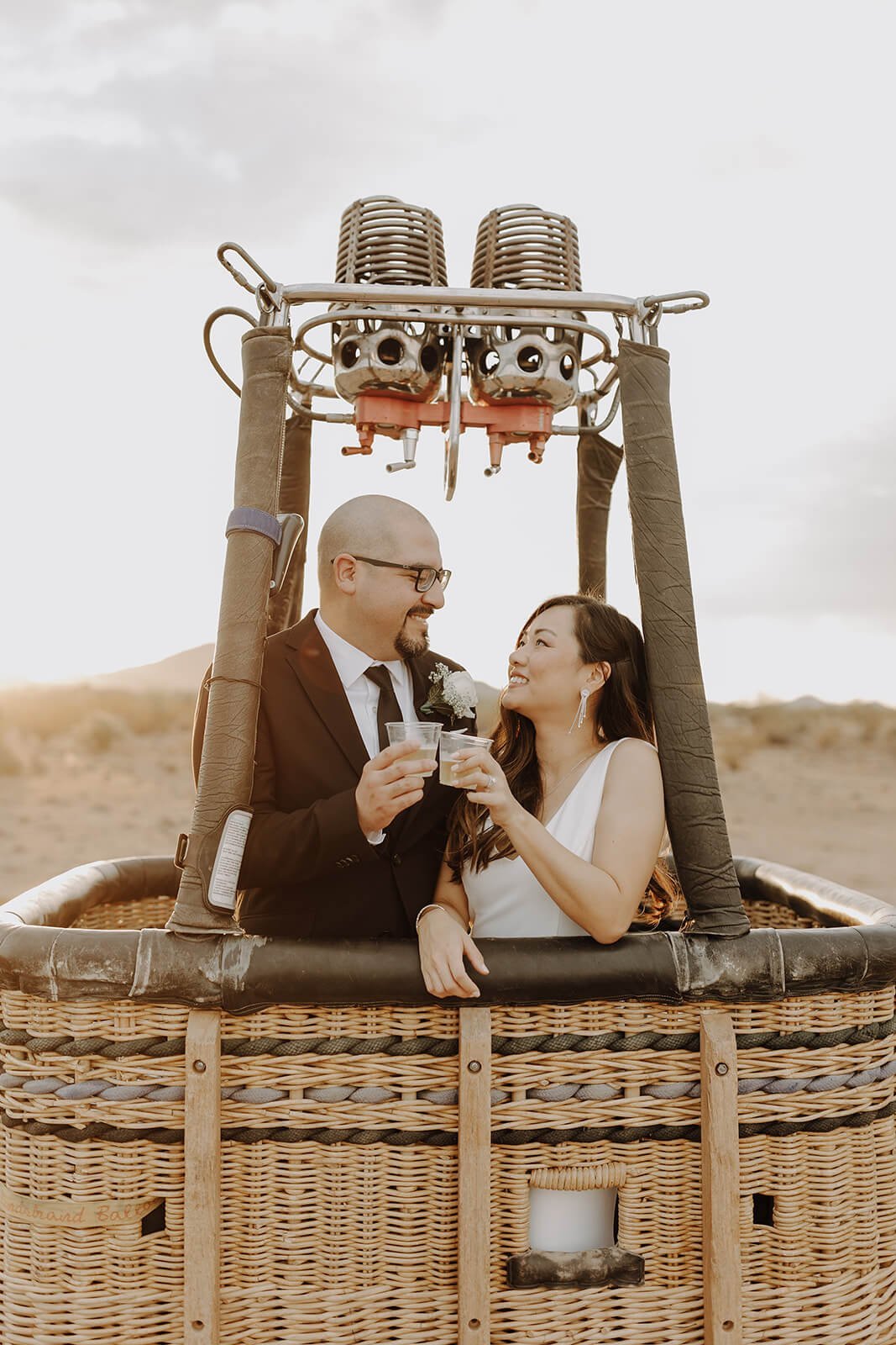 Bride and groom couple portraits inside a hot air balloon basket