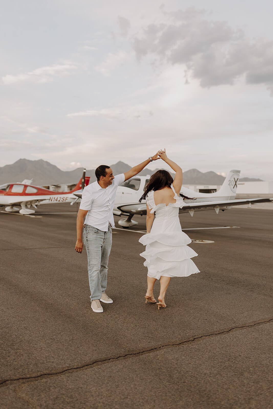 Couple dancing on the air strip at Scottsdale airport for unique engagement photos