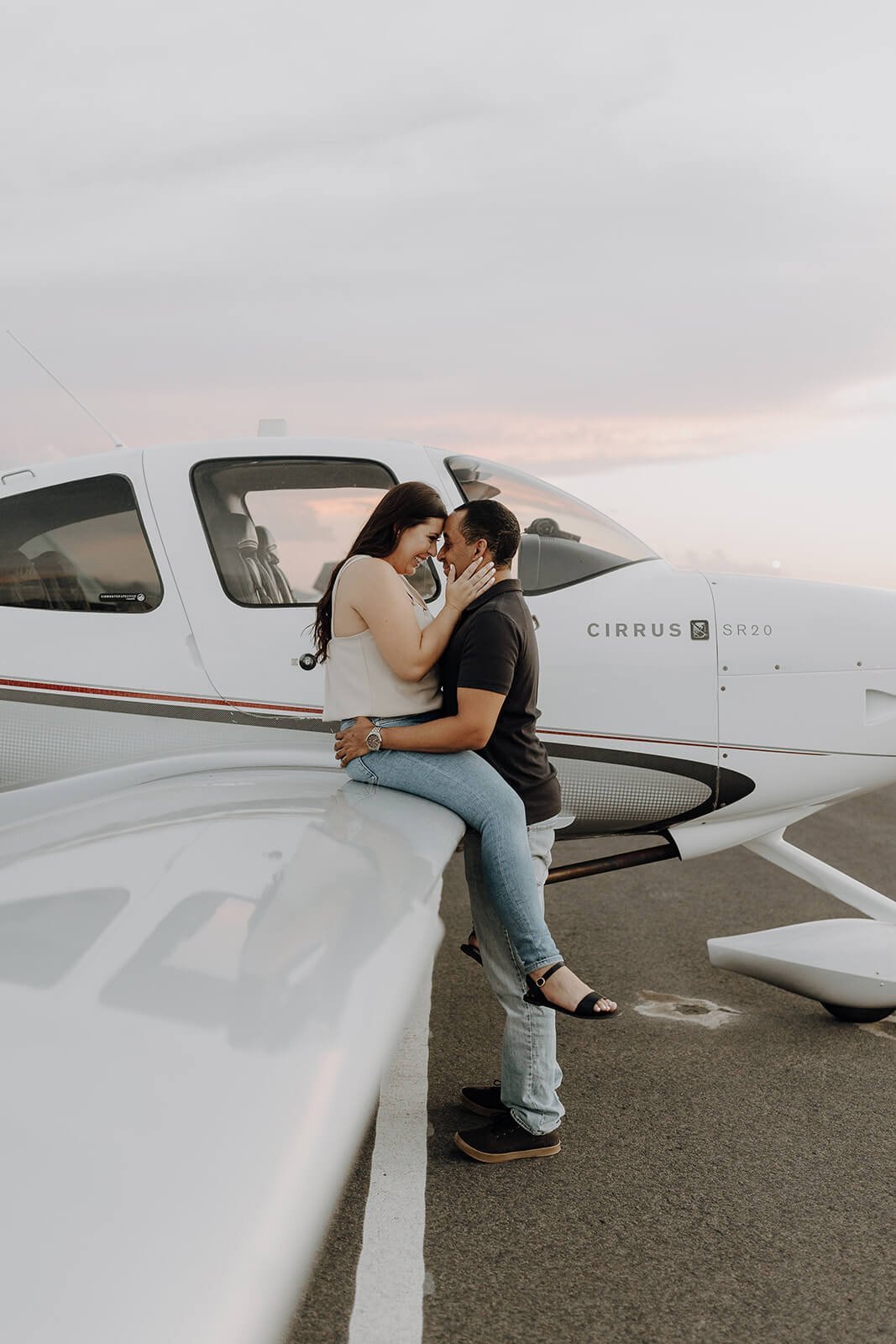 Couple kissing on the wing of the plane at Scottsdale airport