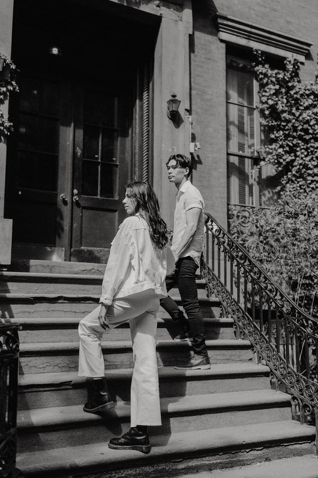 Couple standing on the stoop during New York engagement photos