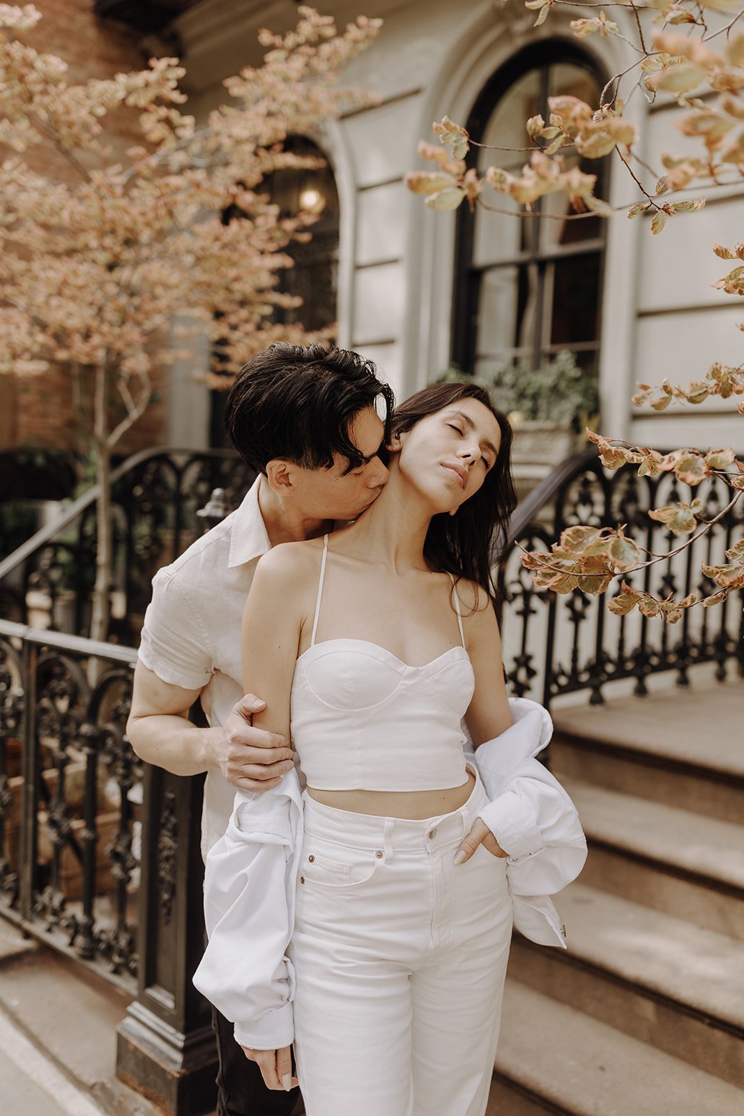 Couple kissing on the stoop during New York City engagement photos