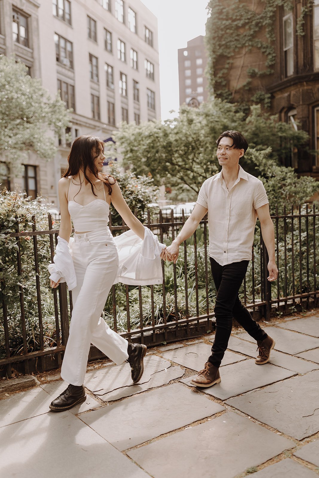 Couple walking down the sidewalk during New York City engagement session