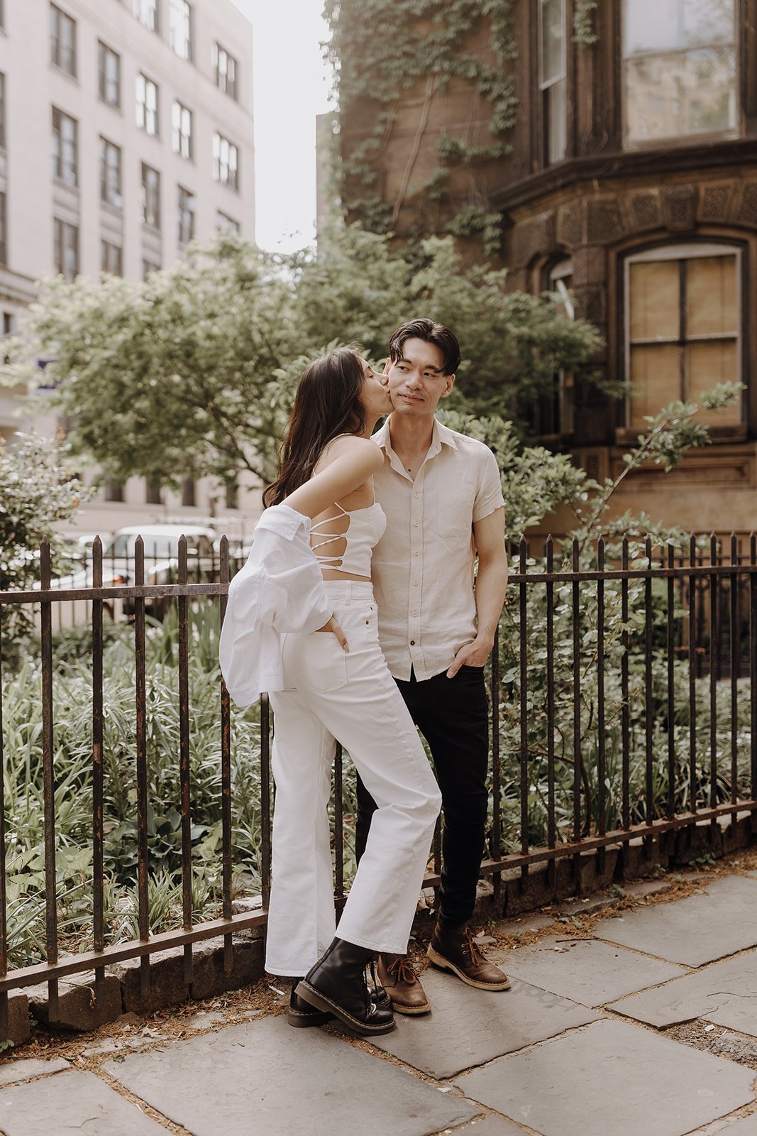 Couple kissing on the sidewalk during New York City engagement session