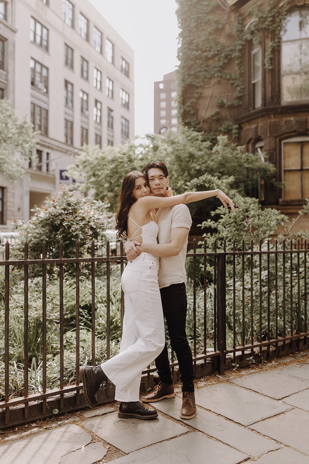 Couple hugging on the sidewalk during New York City engagement session