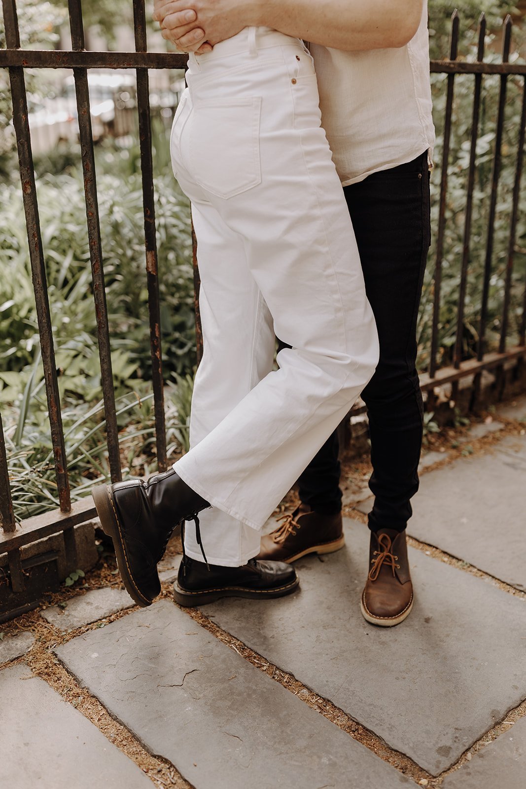 Couple hugging on the sidewalk during New York engagement photos