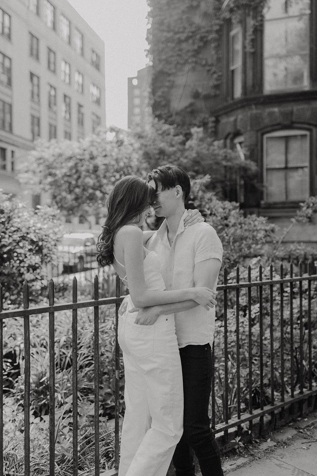 Couple hugging on the sidewalk during New York engagement photos