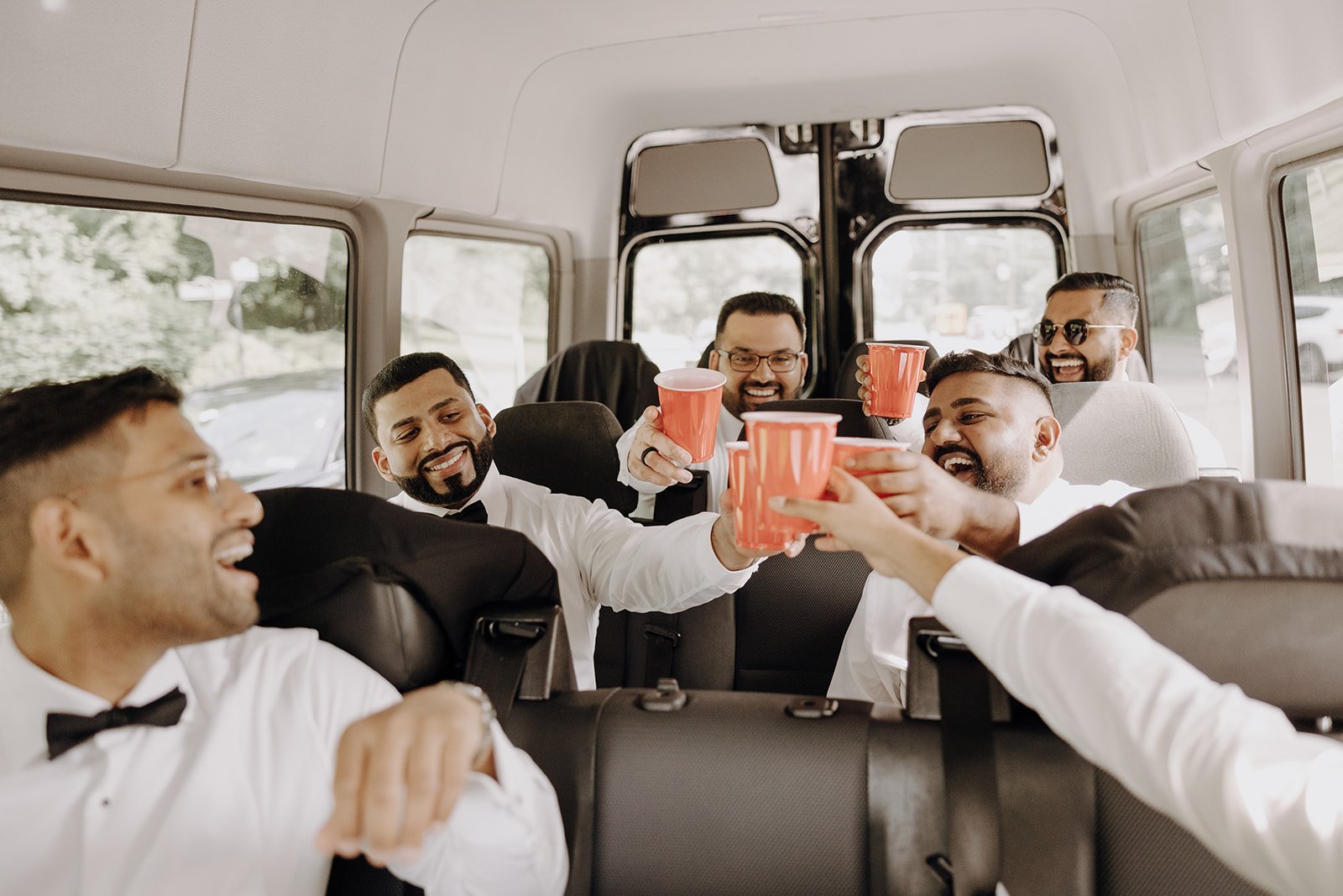 Groomsmen riding in shuttle van to NY wedding venue