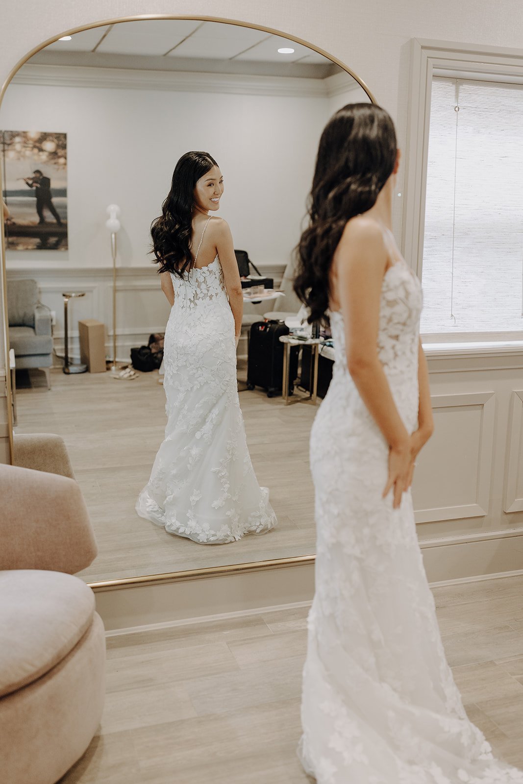 Bride looking at herself in the mirror while getting ready for city wedding at NY wedding venue
