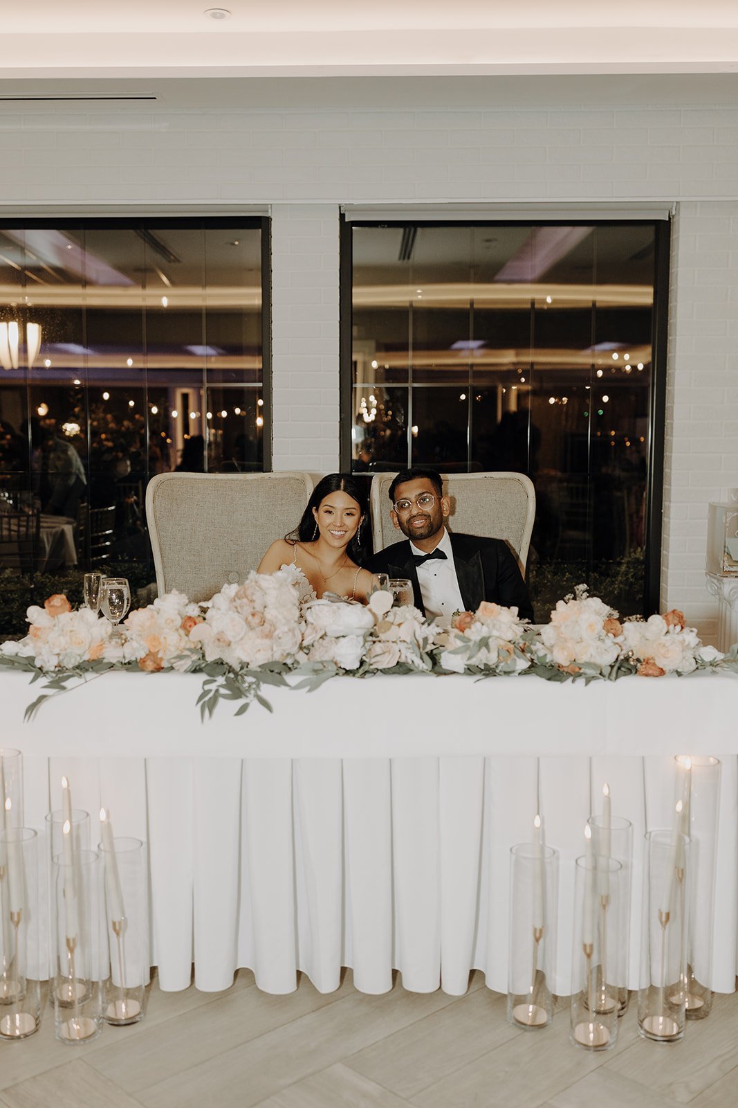 Bride and groom sitting at head table at NY wedding venue