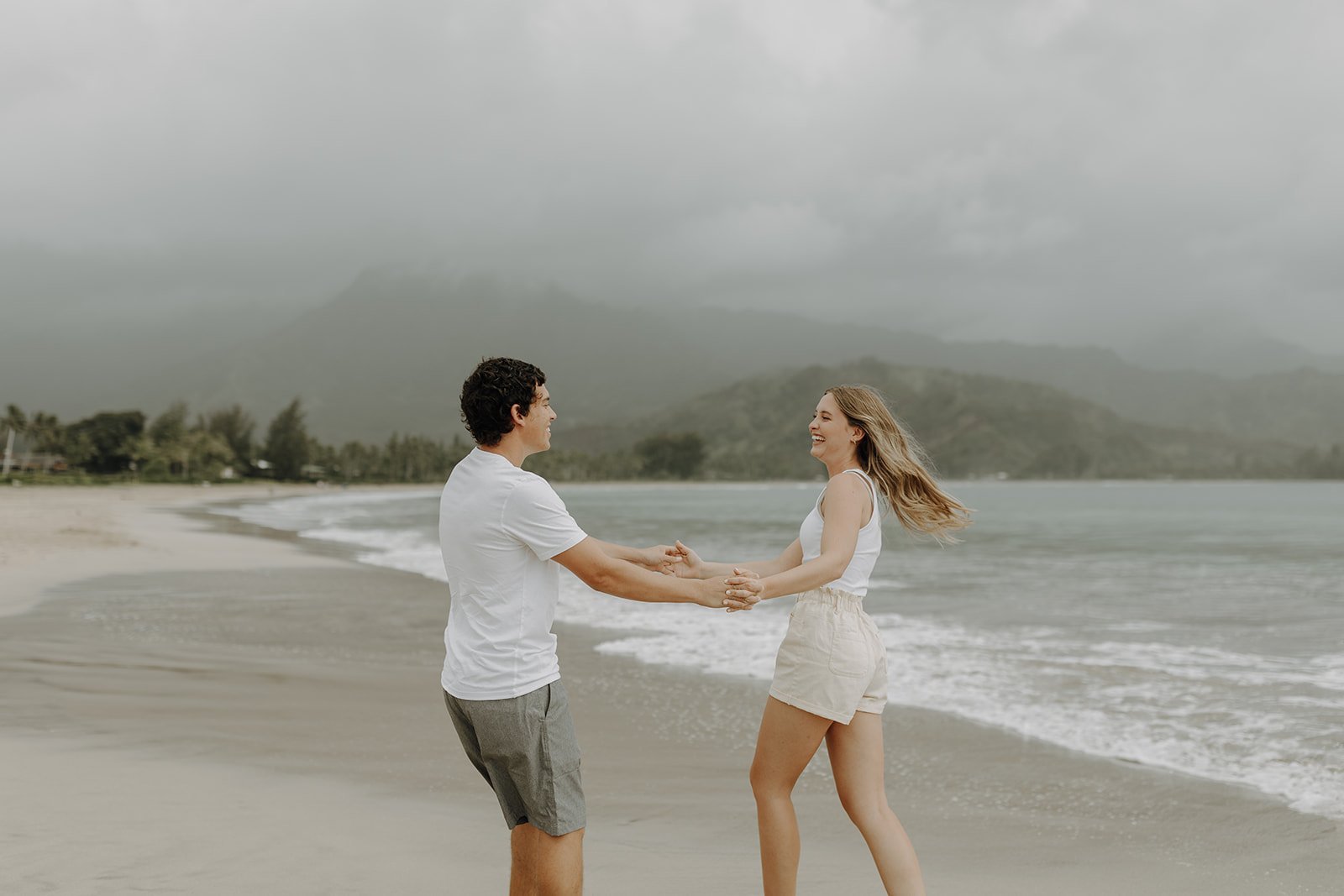 Couple dancing on the beach in Kauai for their Hawaii engagement photos