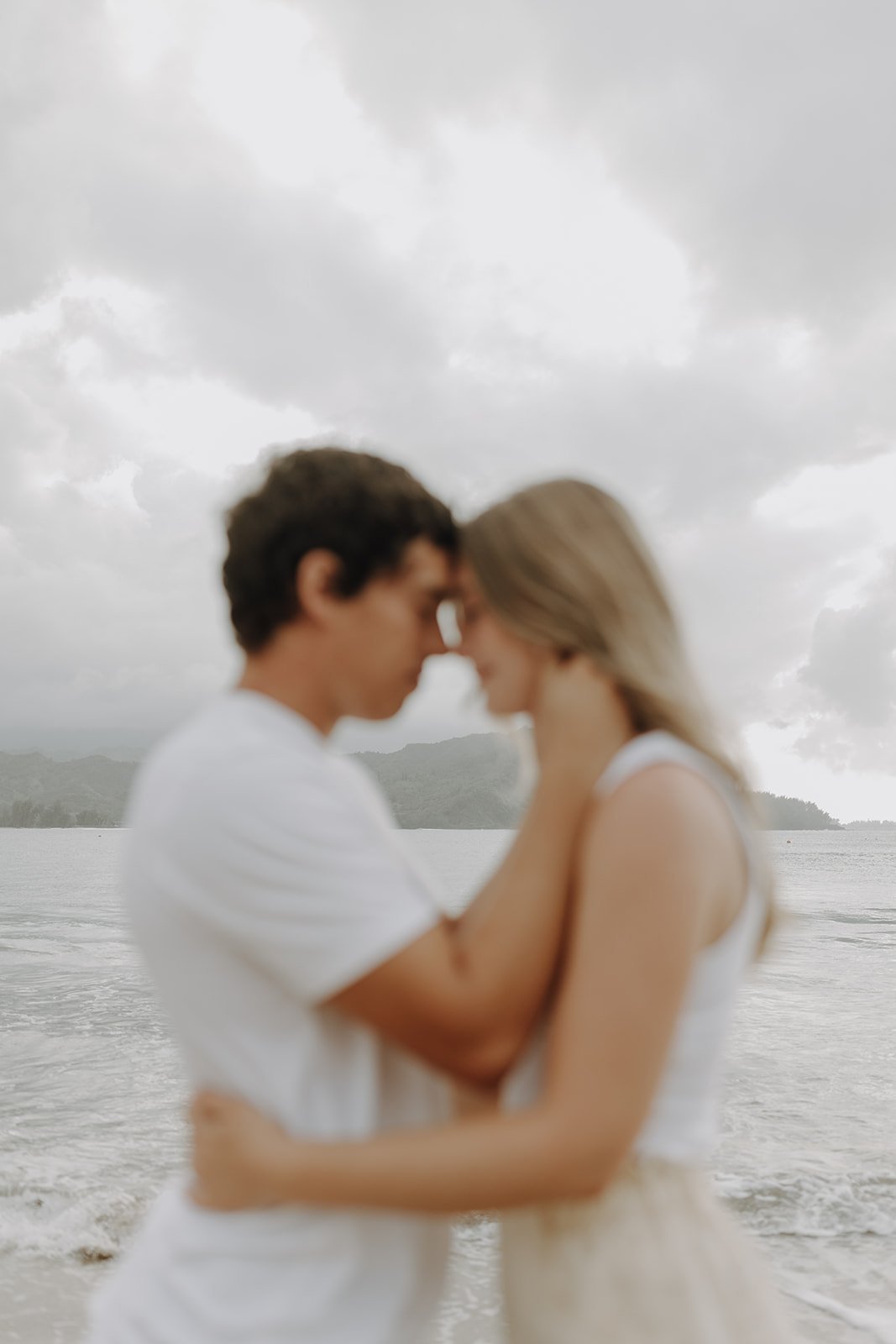 Couple hugging and standing forehead to forehead for Hawaii engagement photos