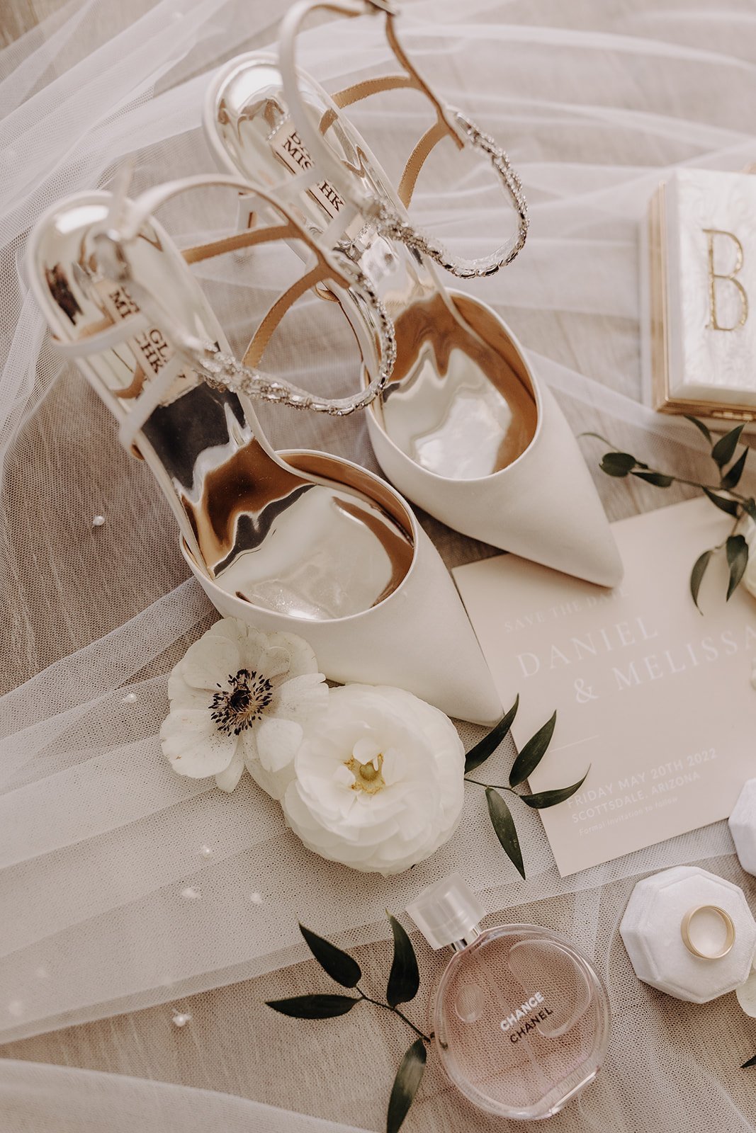 White bridal shoes and flowers flatlay