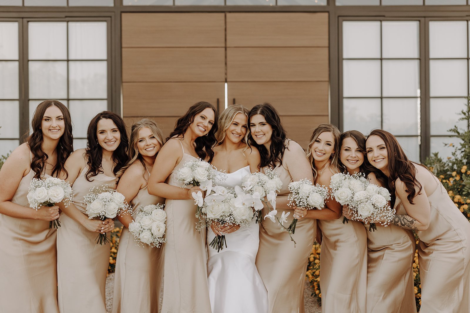 Bride and bridesmaids in champagne colored wedding dresses at the Paseo desert wedding venue