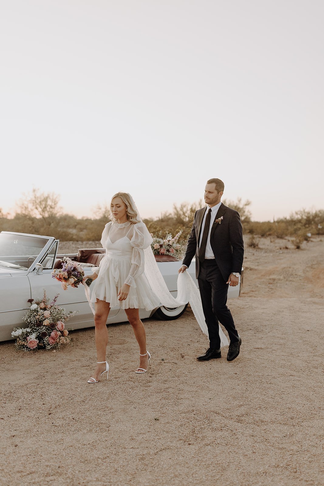 Bride and groom walking hand in hand during wedding styled shoot