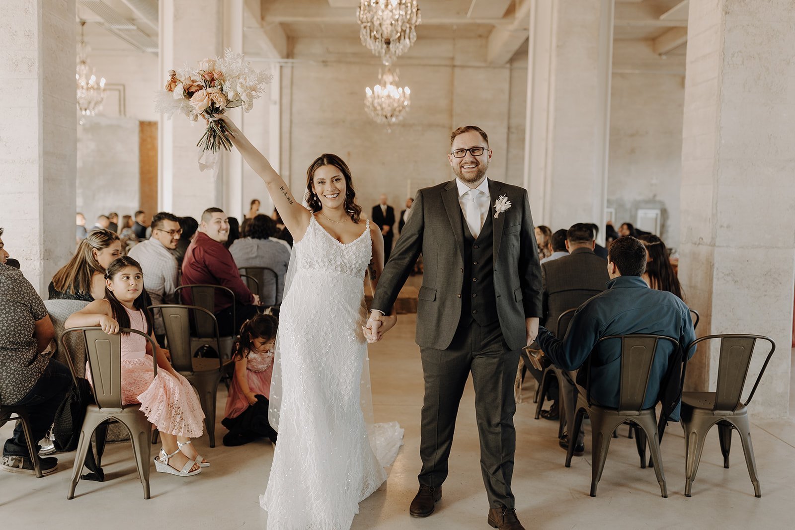 Bride and groom exit Texas wedding ceremony at the Ice Plant Bldg