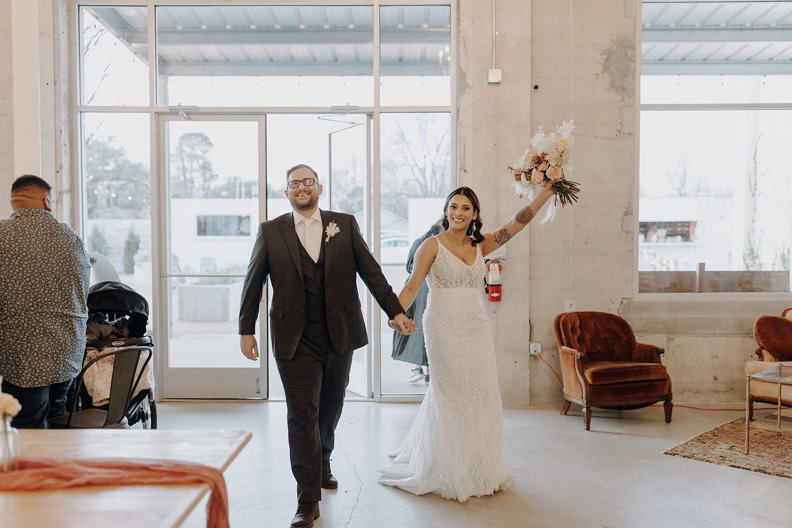 Bride and groom walking into wedding reception at the Ice Plant Bldg