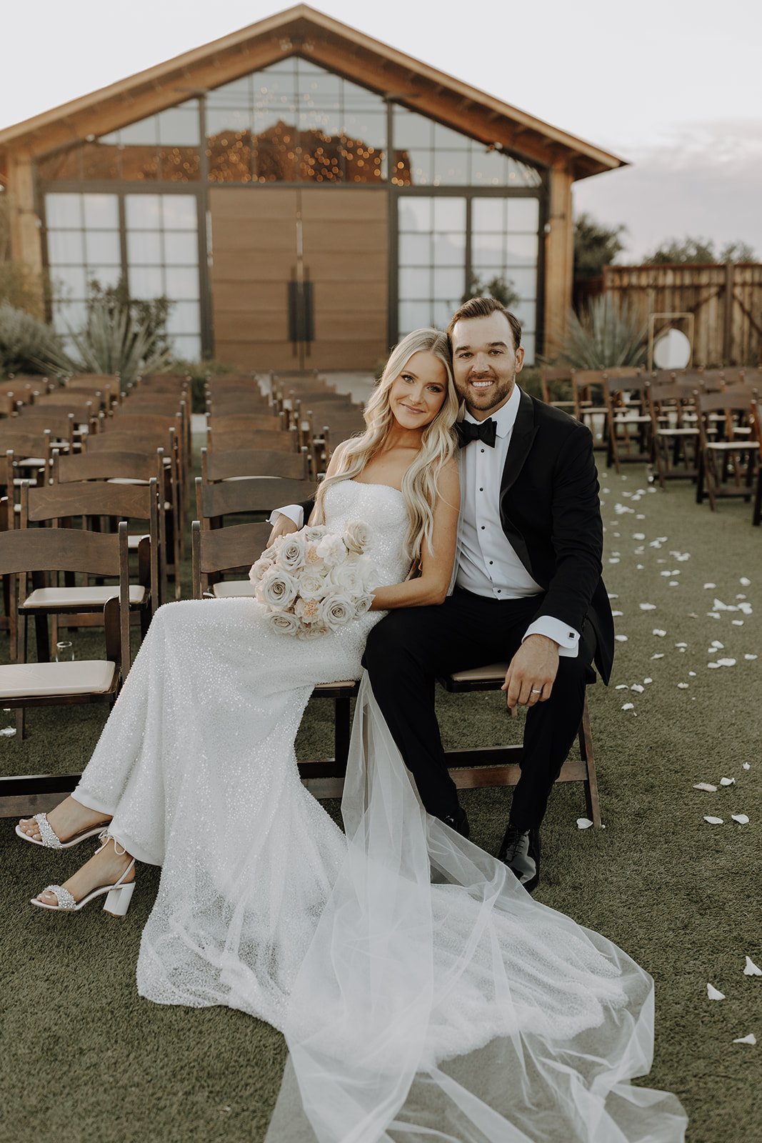 Bride and groom sitting for couple portraits at The Paseo for their desert wedding